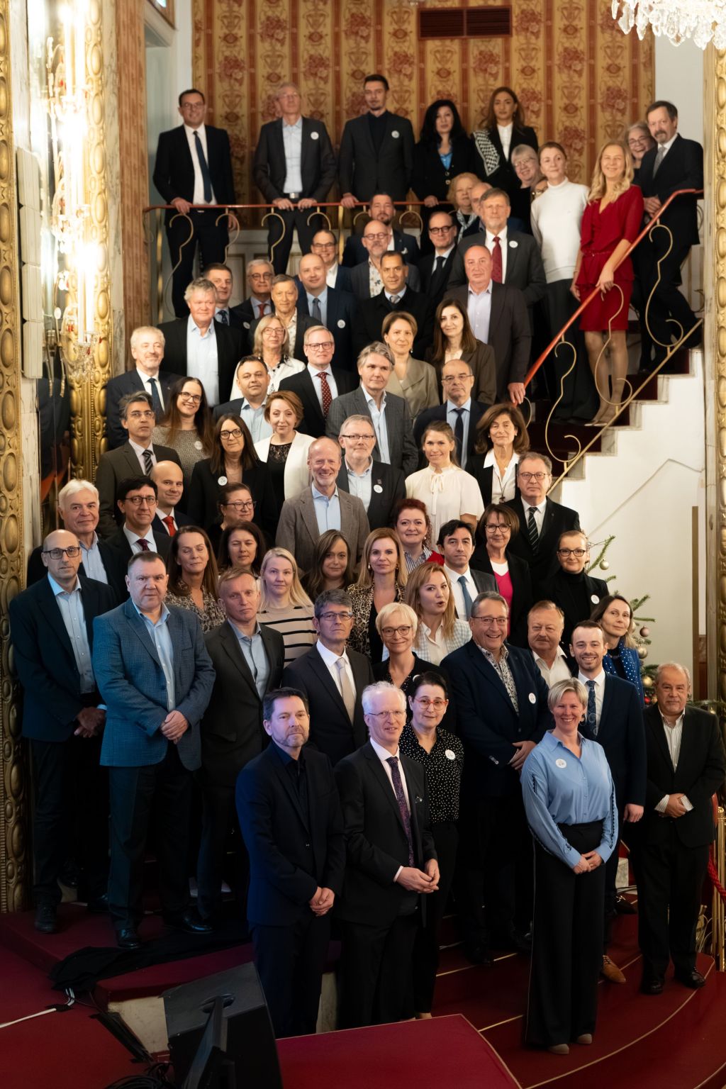 Spoločná fotografia účastníkov zasadania EA GA stojacich na schodisku